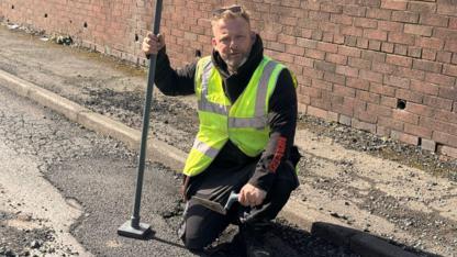 Fed up Dudley man fills pothole himself after near-miss